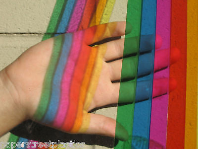 transparent tape on window, colored sunlight on hand